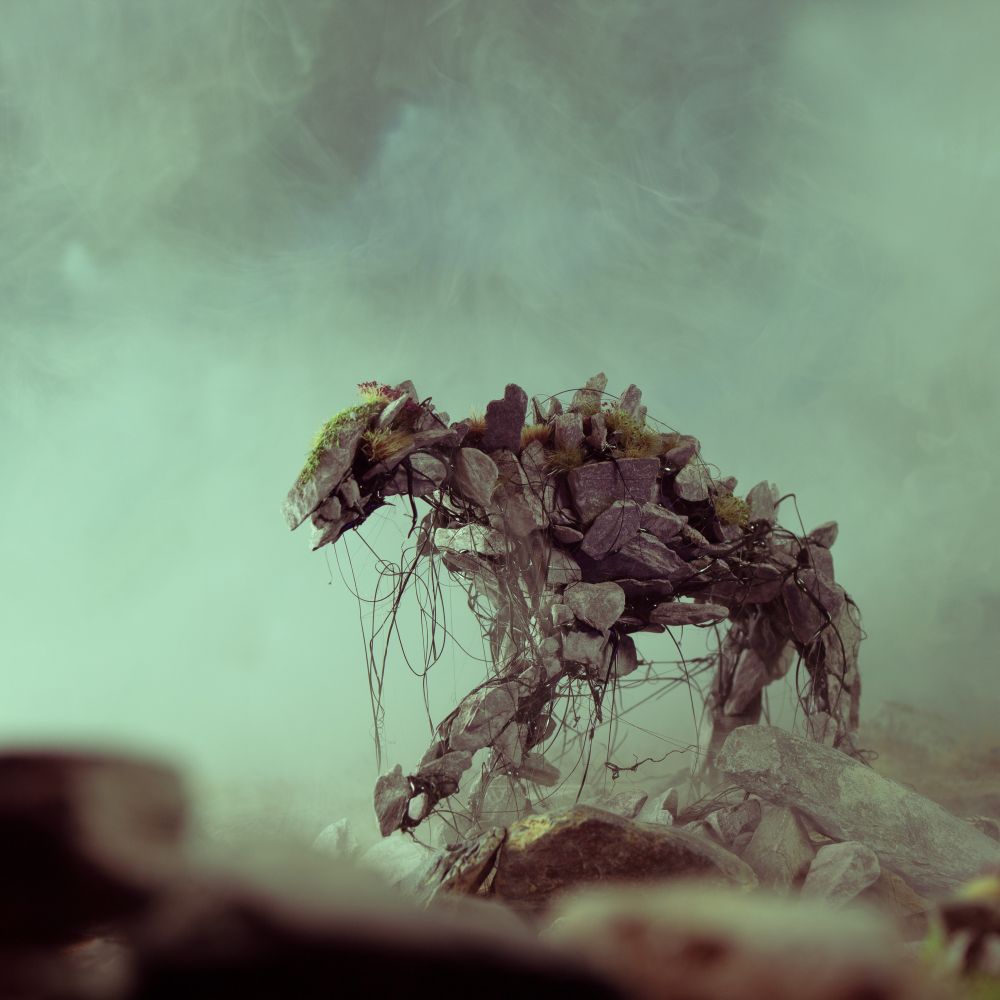 An evil spirit, in the shape of a quadrupedal canine type of thing, from Maskwitches of Forgotten Doggerland made out of wire, glue and stones. 