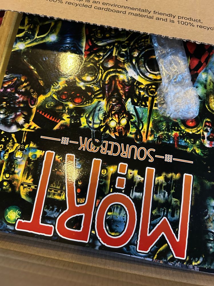 A photo of the Mort sourcebook for SLA Industries, updated down in its cardboard packaging. 