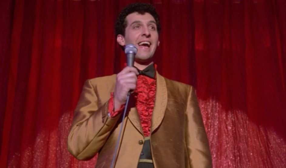 John Turturro as the host of the Magic Club in Desperately Seeking Susan