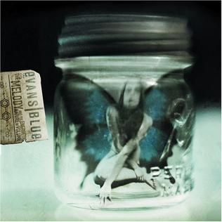 Evans Blue: The Melody and the Energetic Nature of Volume. A girl with butterfly wings sits in a jar. 