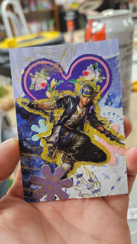 Locke Cole from Final Fantasy 6 is crouched with his daggers out and is outlined in gold acrylic pen. Behind his head is a Victorian style purple heart with a pink outline and white roses laid inside. Behind Locke is a cut out doily which covers the corner of the background, a blue painted texture, and a torn piece of textured paper with Violet and pale blue diamonds that create an interlocking pattern. The figure of Locke is surrounded by three 60's style colourful flower silhouettes. 
