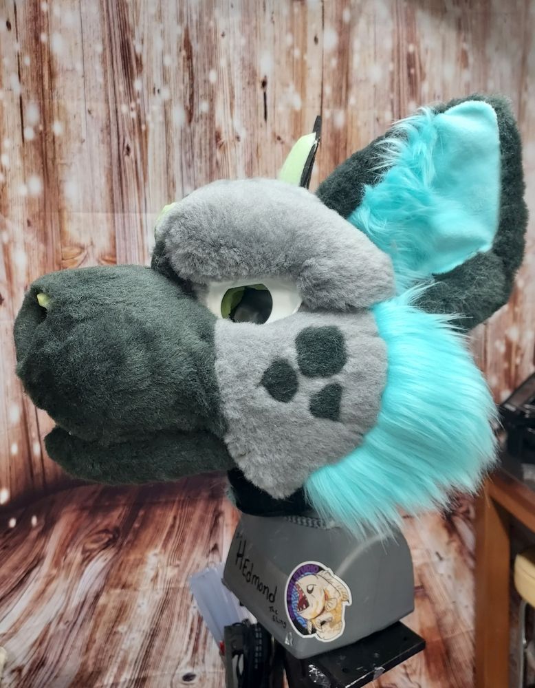 gray and blue hyena furniture head. the fur isn't glued down yet so it's extra lumpy.  I lovingly refer to this part as the "probably ate bees"stage