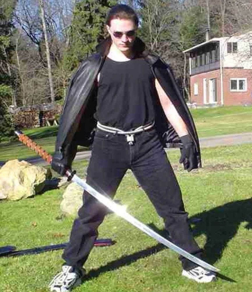 NOT ben shapiro (i think) with a katana and a coat cape