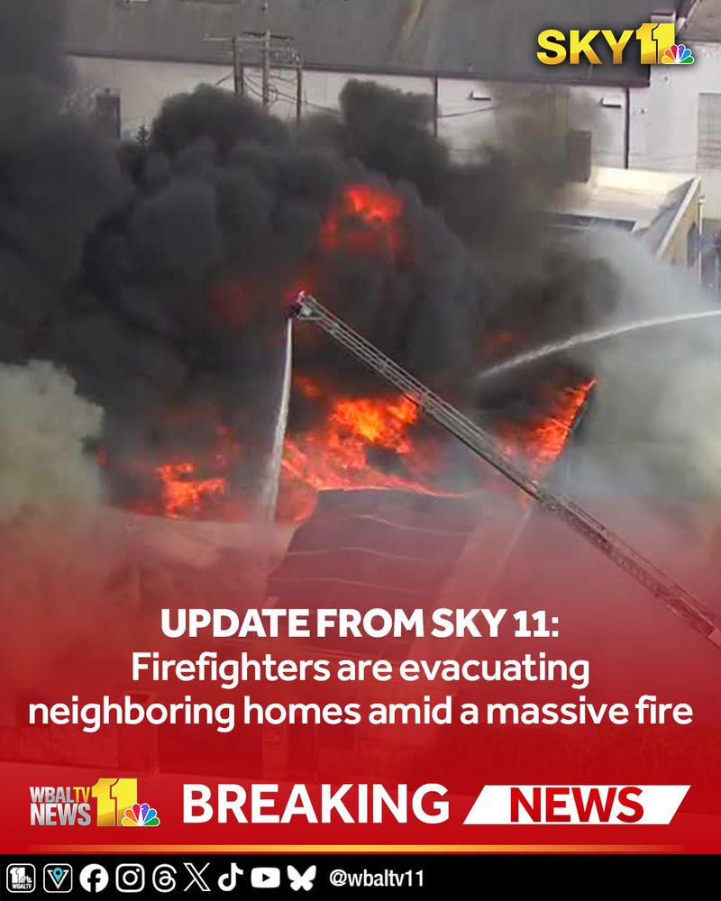 Firefighters are evacuating homes amid heavy flames and smoke billowing from a large fire in North Baltimore, SKY 11 reports