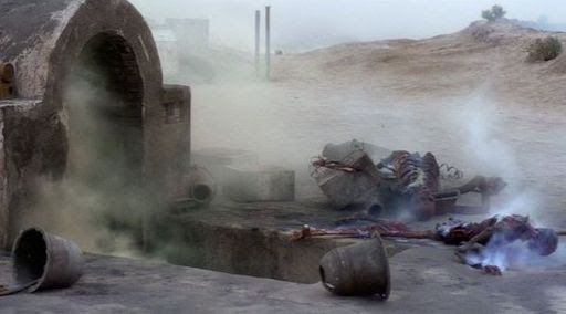 The steaming skeletons of Owen & Beru Lars on the doorstep of their burned-out homestead in Star Wars. 