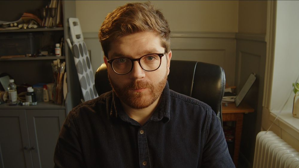 A man attempting to smile