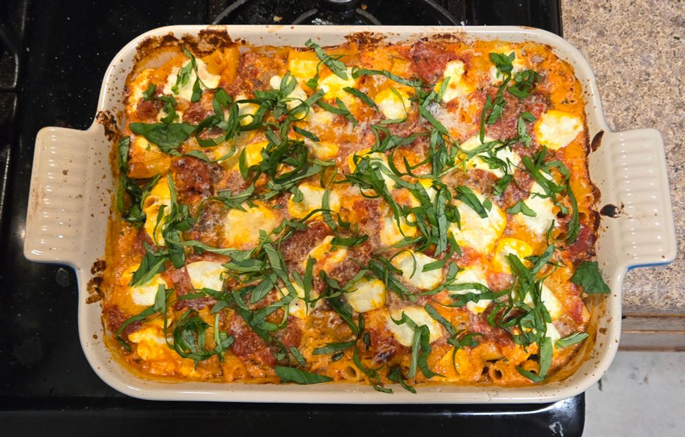 a baking dish of baked ziti. you can't really see em but there's meatballs in it.