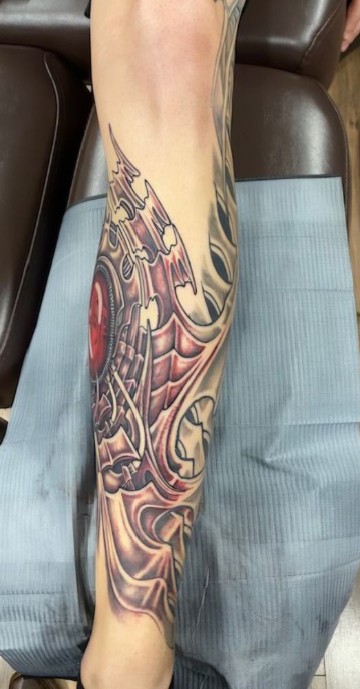 Picture of the fresh biomechanical tattoo on the front of my left shin.