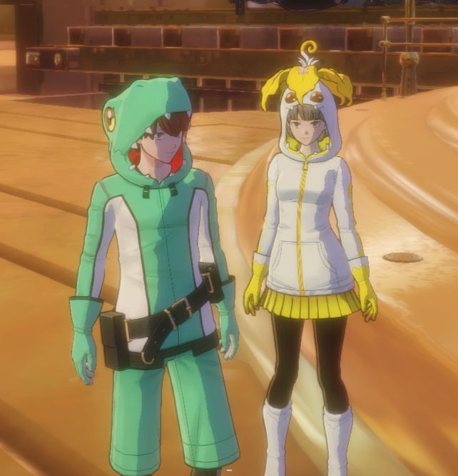 The Body A player character and Inori Misono in Digimon Story: Time Stranger, wearing the Digimon Costume DLC. The colors have been altered- the Agumon costume is teal and white, like the player character's default outfit, and the Palmon costume is yellow and white. 