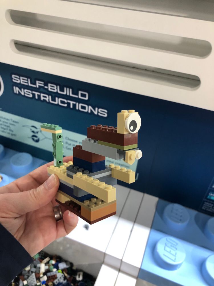 Hybrid dinosaur built with odd bits of Lego, and looking vaguely dinosaur-eske, has tail and T-Rex arms, built to hover rather than walk 😂