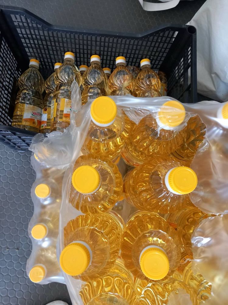 Ölflaschen, von oben fotografiert 
In Großgebinde abgepackt
Goldgelb, oben mit gelbem Schraubverschluss