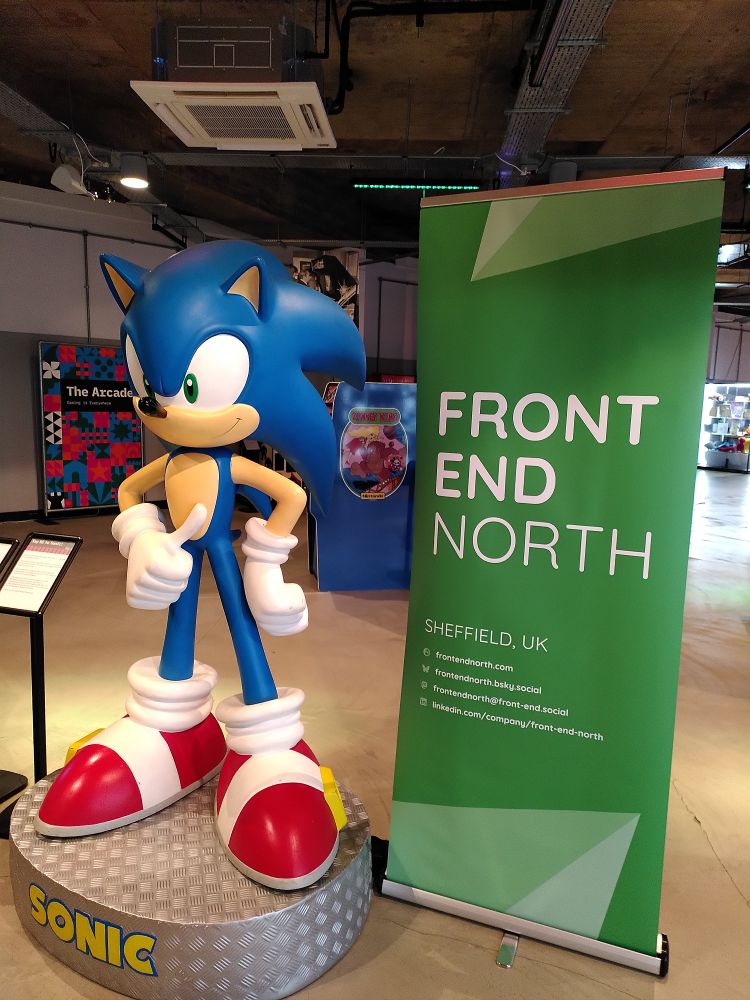 A larger sonic the hedgehog model next to a front end north banner stand 