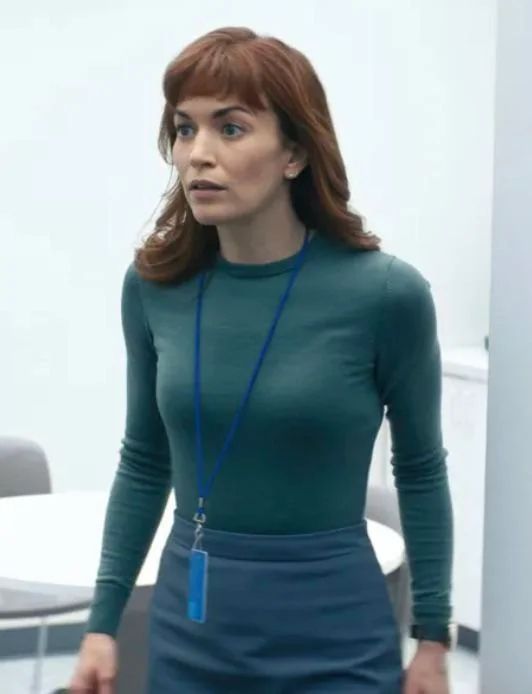 Helly R from “Severance” in her blue-green dress, lanyard and iconic short bangs