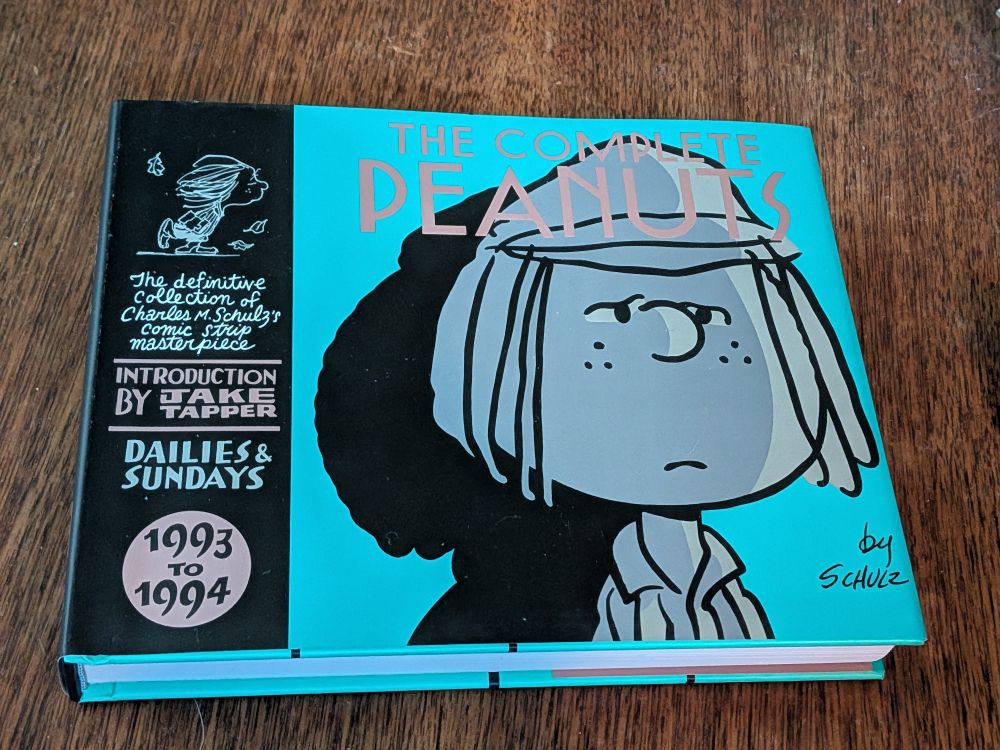 Photo of the hardcover edition of The Complete Peanuts 1993 to 1994 by Charles M. Schulz, featuring Peppermint Patty on the front cover 