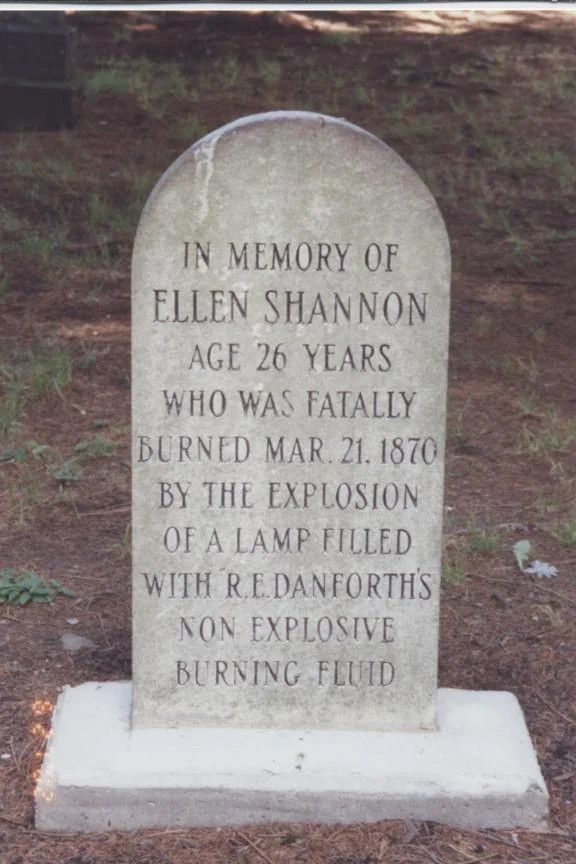 headstone: The epitaph reads: "In memory of Ellen Shannon, age 26 years, who was fatally burned Mar. 21, 1870 by the explosion of a lamp filled with R.E. Danforth's non explosive burning fluid."