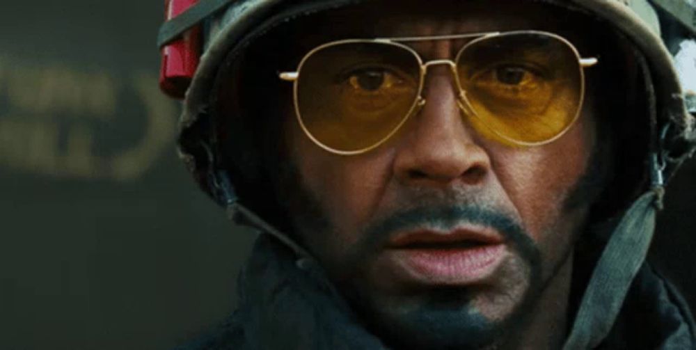 a man wearing sunglasses and a helmet with the word survive written on it