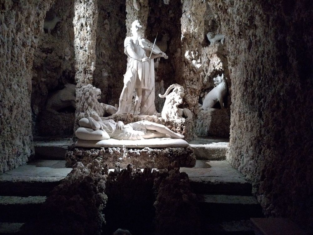 A baroque style grotto part of the water trick fountains with broke figures like lions wolves and bears depicting the scene from antique mythology