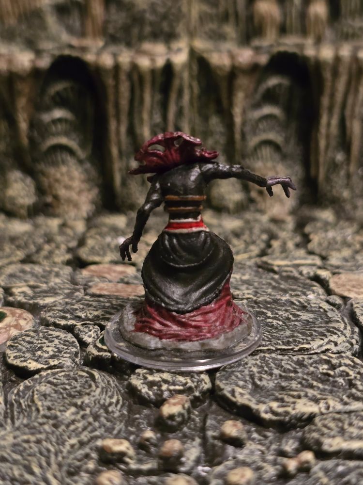 A back view of the Mind Flayer's mini, showing off their high collar.