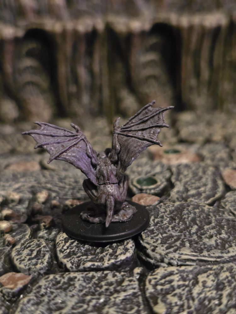 A back view of the left gargoyle's mini, showing off their wings and tail.