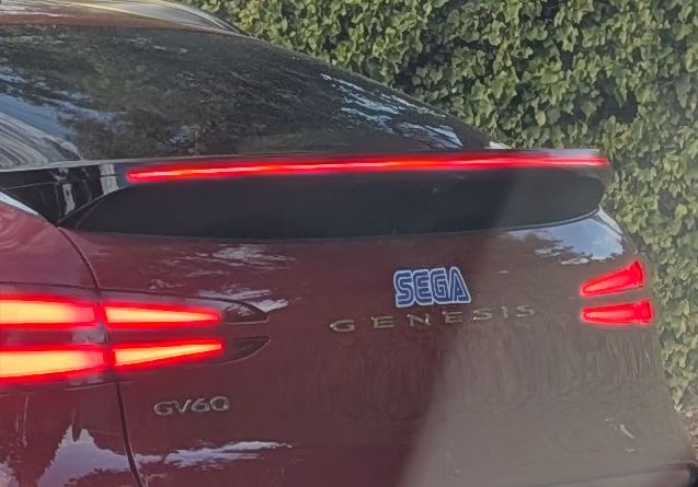 Rear of a Genesis GV6O car with a SEGA sticker placed right above the Genesis.
