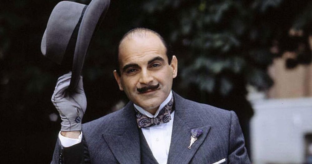 TV detective Hercule Poirot raising his hat in greeting.