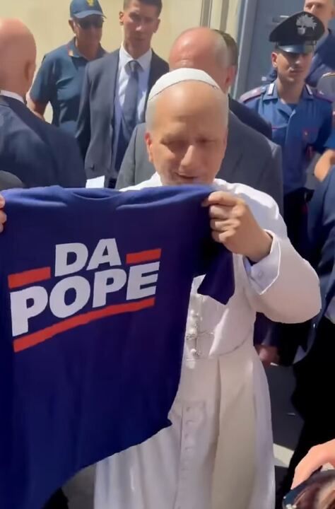 The pope holding up a t-shirt in Bears colors reading "Da Pope"