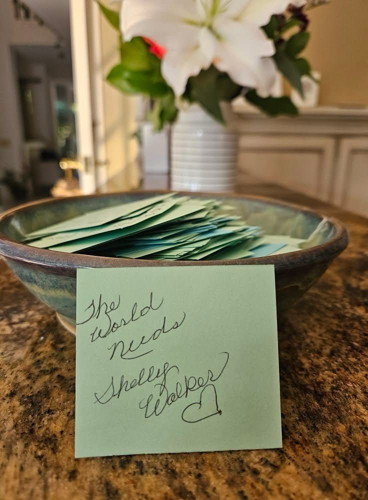 A picture taken by the recipient (now an Associate Reverend) of the spiral bowl after she pulled one of the affirmations provided by the community. It reads, “The world needs Shelly Walker <3.”