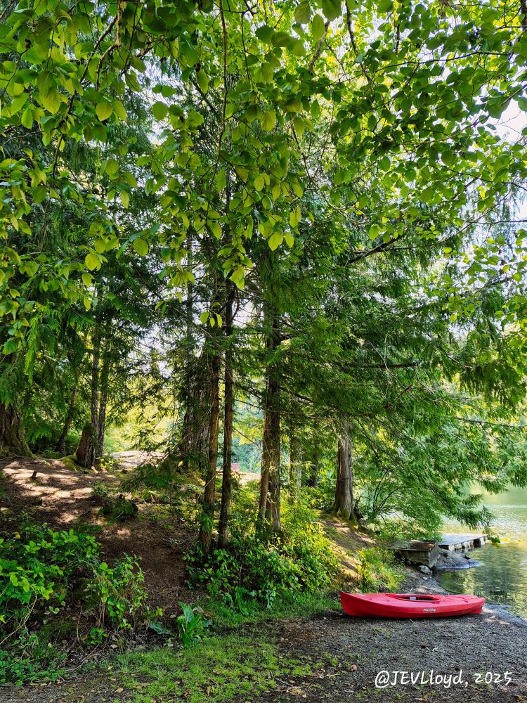 Photograph taken by Jennifer Lloyd of a red kayak on the shore of a lake