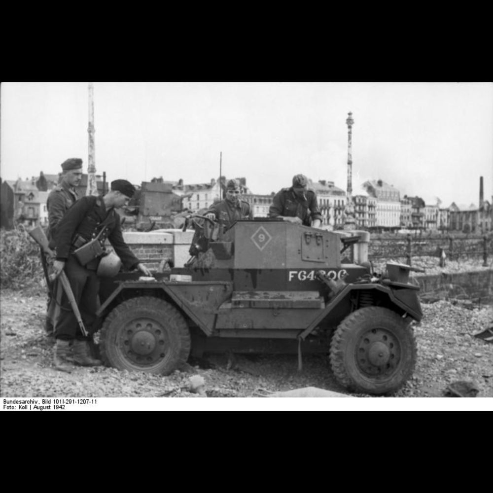 German troops inspecting a British Daimler Scout Car captured during the failed raid on Dieppe, Fran...