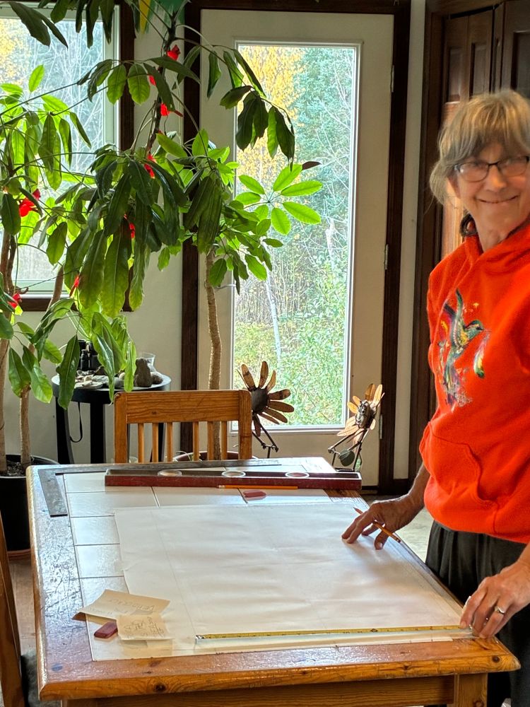 Older, White lady laying out a hand-painted sign to be