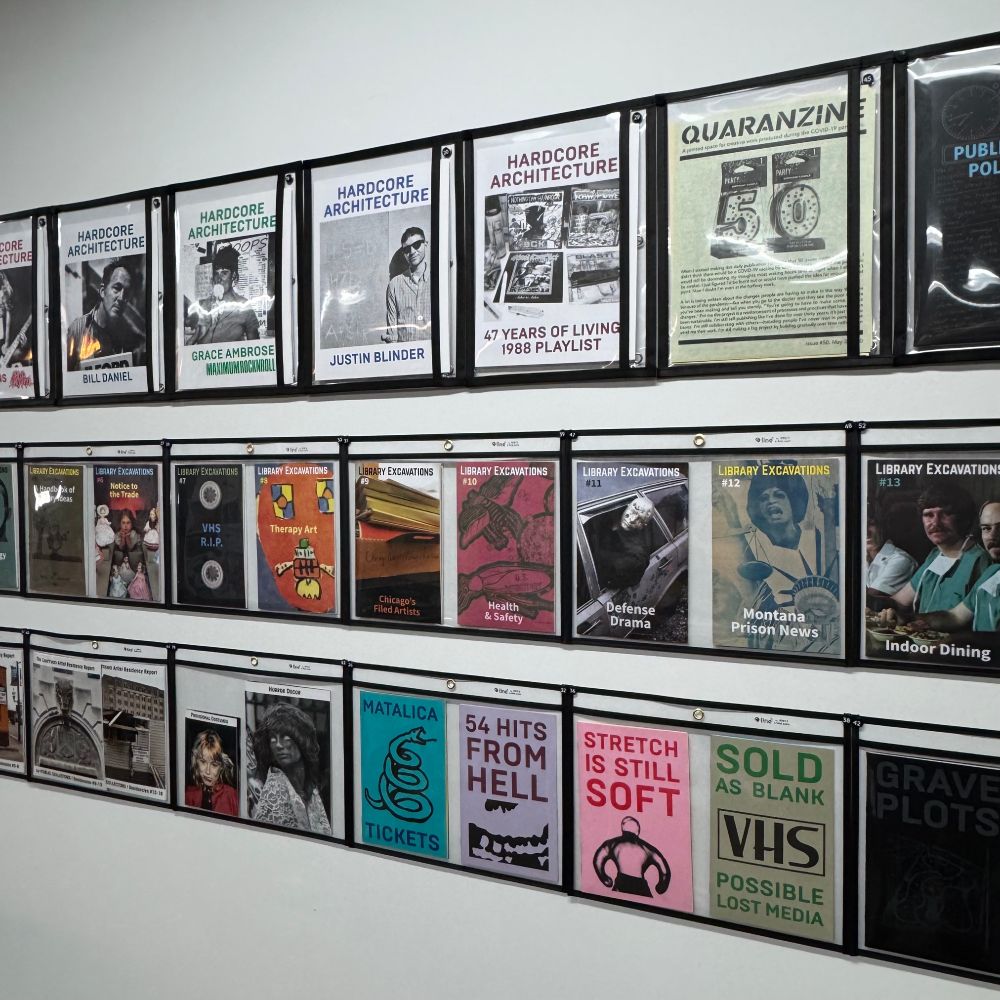 Three rows of Public Collectors booklets and zines installed on a wall at Quimby's Bookstore on 1854 W. North Ave. in Chicago. 