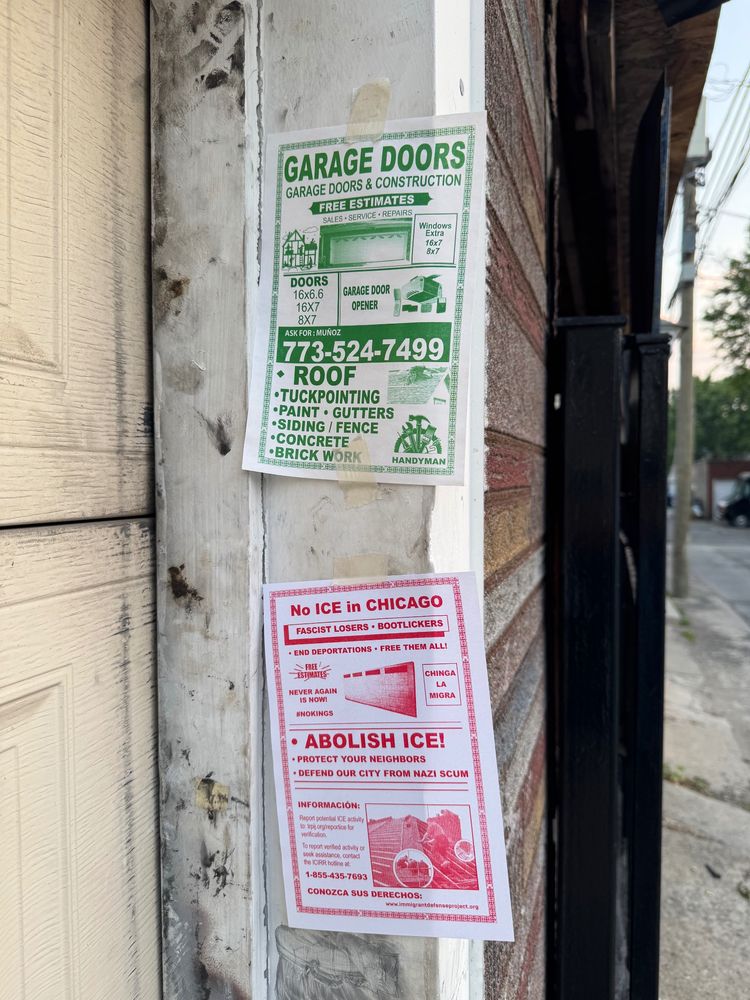 A flyer with red ink text/graphics in the style of those made by contractors selling their services, but with content about Abolishing ICE. It's taped to the side of a garage door and includes information about who to contact if you see ICE activity and links to Know Your Rights information. 

Another flyer for a contractor is taped above it).