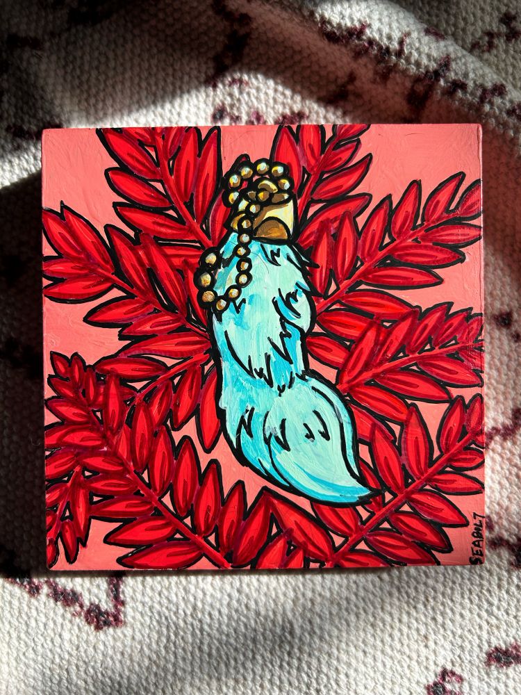 Rabbits foot brightly colored with fern leaves 