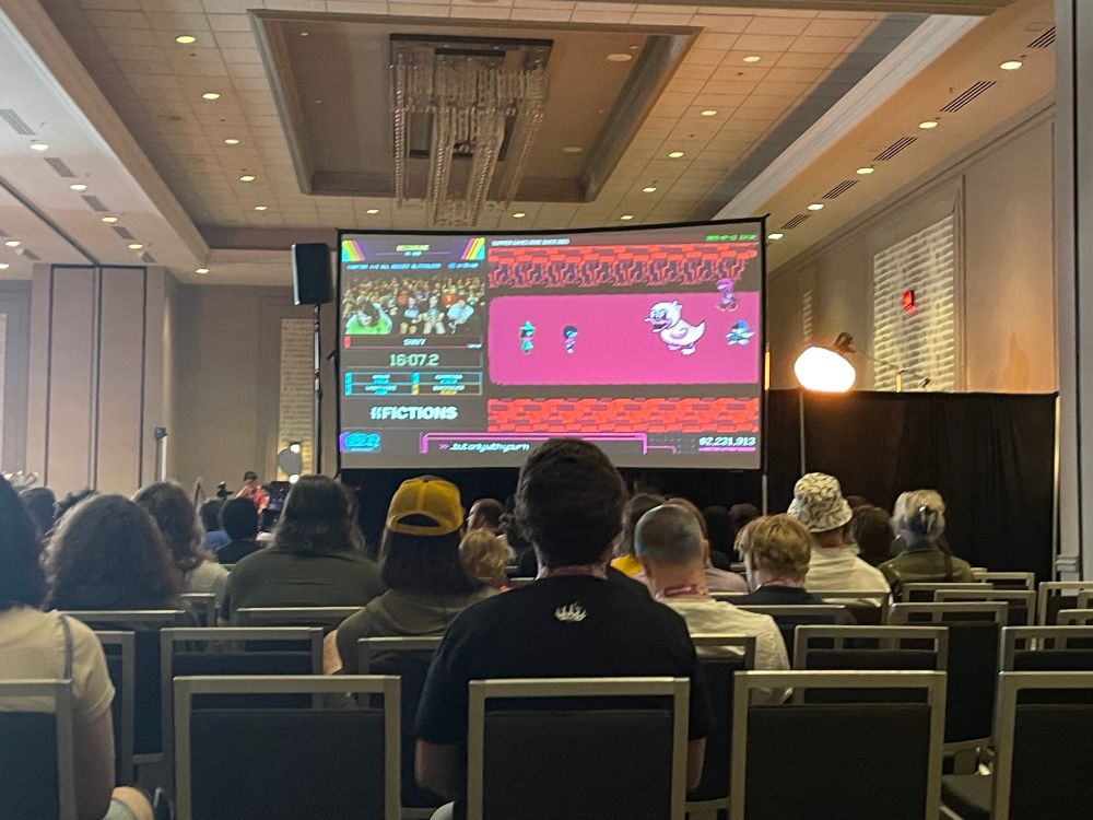 Shayy playing Deltarune in SGDQ. They are at the scene of the duck thrash machine showing up.