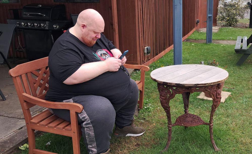 Fat guy sitting on a bench