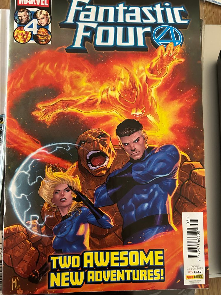 Cover showing the fantastic four poised for action 