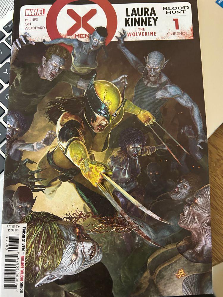 Laura in a yellow uniform claws out fighting off vampires who are attacking from all sides 