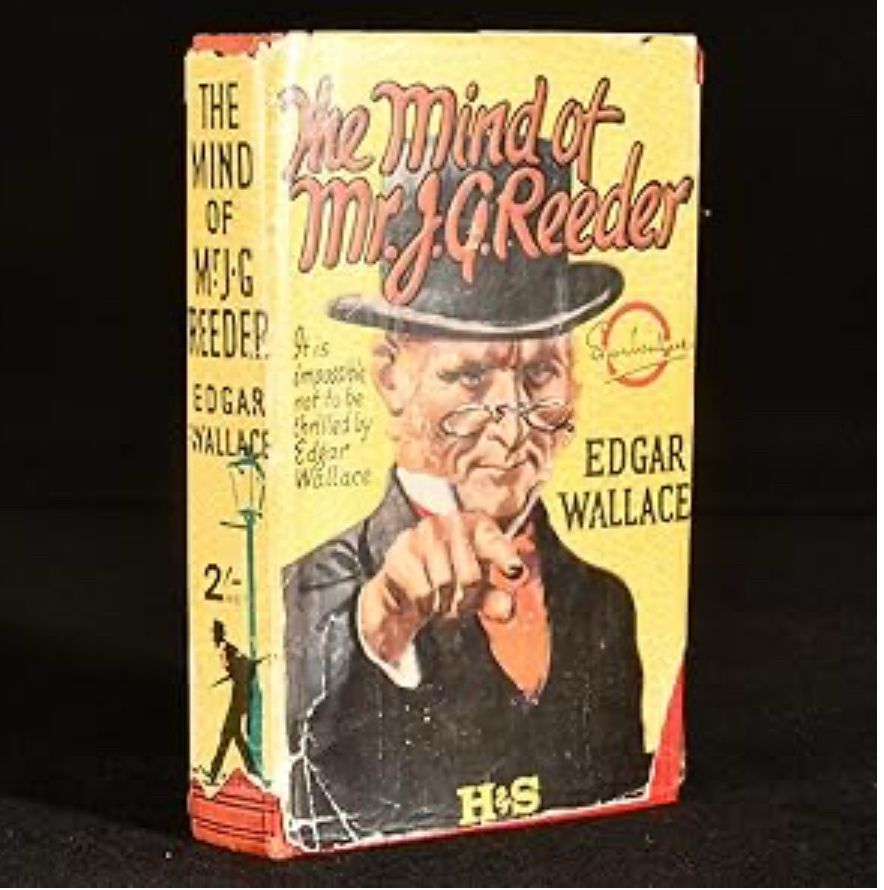 Old hardback edition the cover showing an Edwardian looking gentleman with sideburns and pince-nez pointing towards the reader  