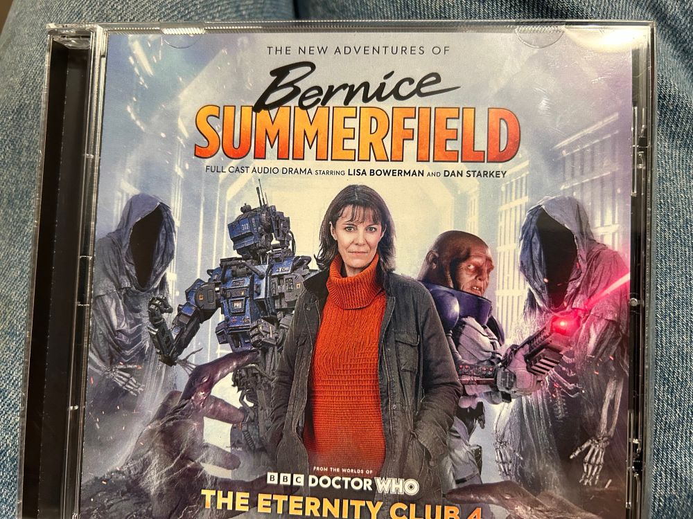 Benny flanked on either side by a robot and a Sontaron surrounded by skeletons in monks robes 