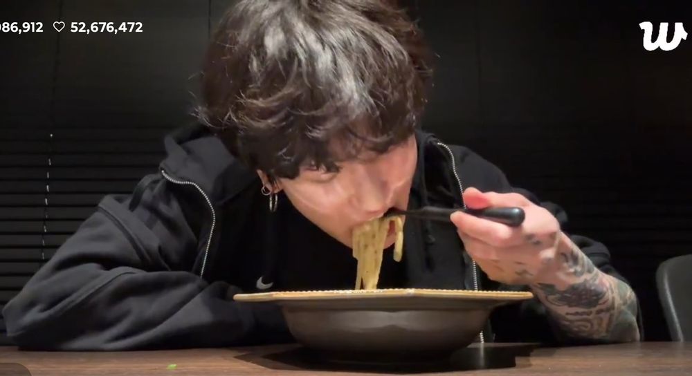 Jungkook with his insanely cute fluffy hair scarfing a truly hugeous forkful of pasta.