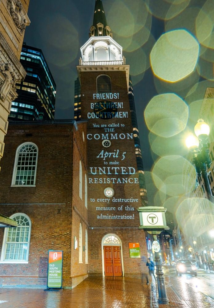 A photo of Boston’s Old South Meeting House (where the Boston Tea Party began) with the following words projected onto it: “FRIENDS! BRETHREN! COUNTRYMEN! You are called to THE COMMON April 5 to make UNITED RESISTANCE to every destructive measure of this administration!”