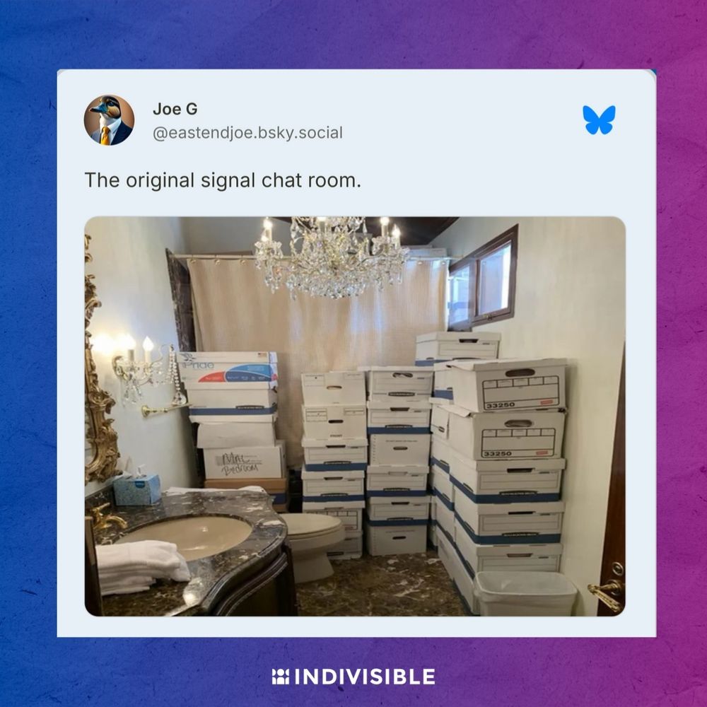 Image of a bathroom filled with stacked white pizza boxes from Domino's, featuring a lit chandelier and a vanity mirror.