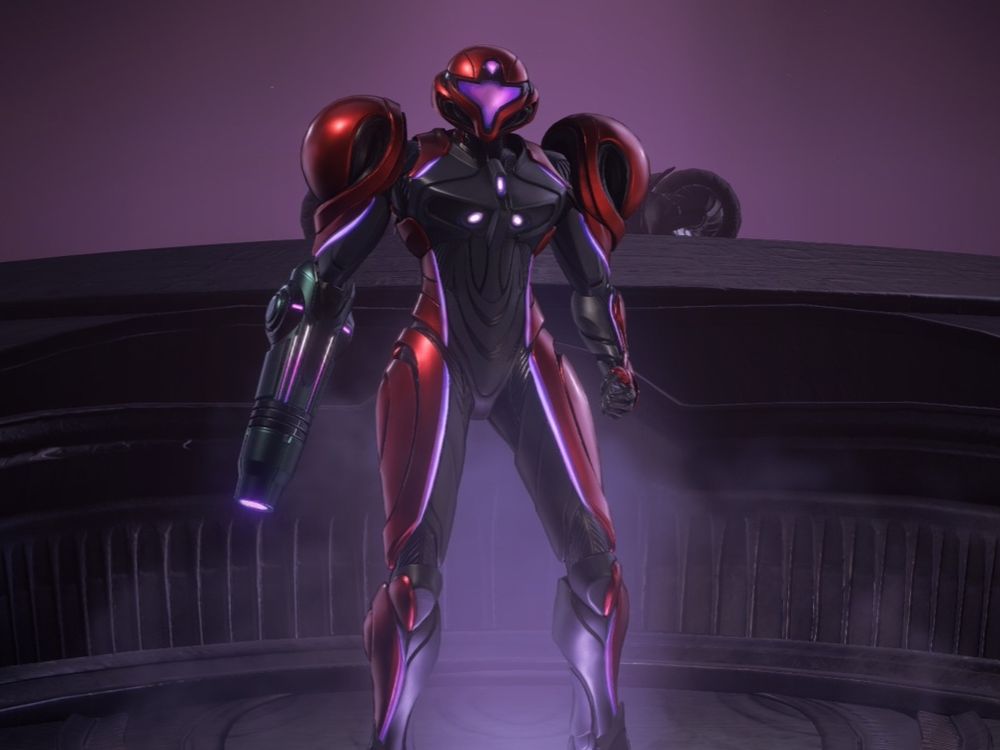 A screenshot of Samus Aran in her new VI-O-LA suit. A sleek red and black design that seems to emulate a biker's suit while maintaining Samus' iconic look.
