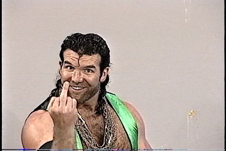 WWE Wrestler Razor Ramon sticking out his middle finger to the camera