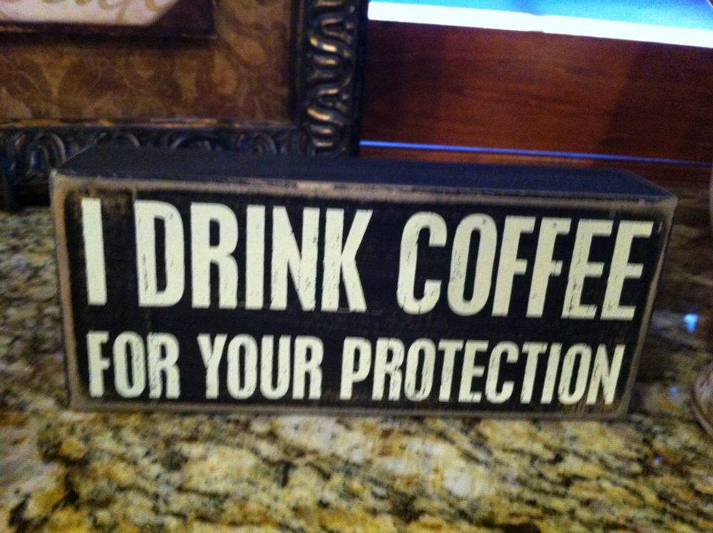 Sign in kitchen: “I drinks coffee for your protection”