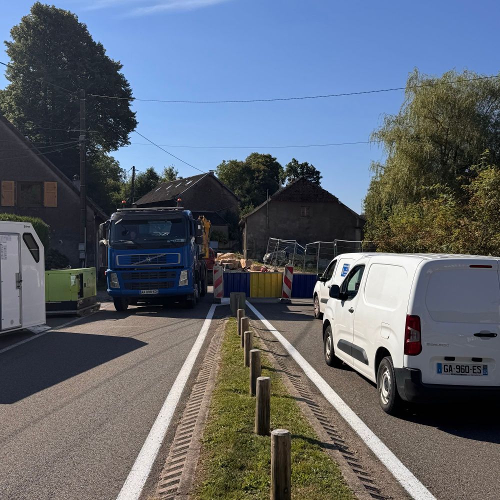 Two lanes of a French D road blocked by Lorries, barriers and vans 