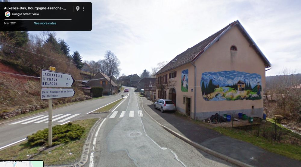 Google street view showing D13 road towards Belfort, with a house on the right and its painted mural depicting rural life