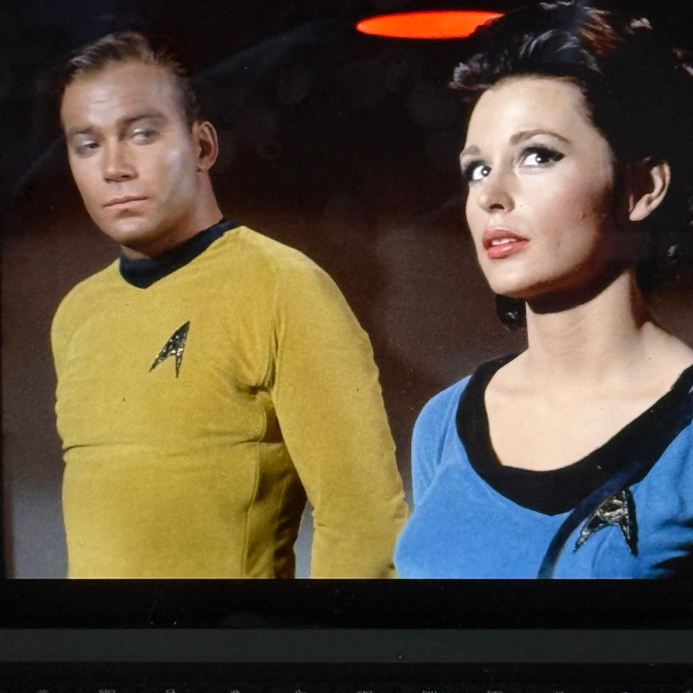 Captain Kirk with a very pretty crew member in the transporter room 