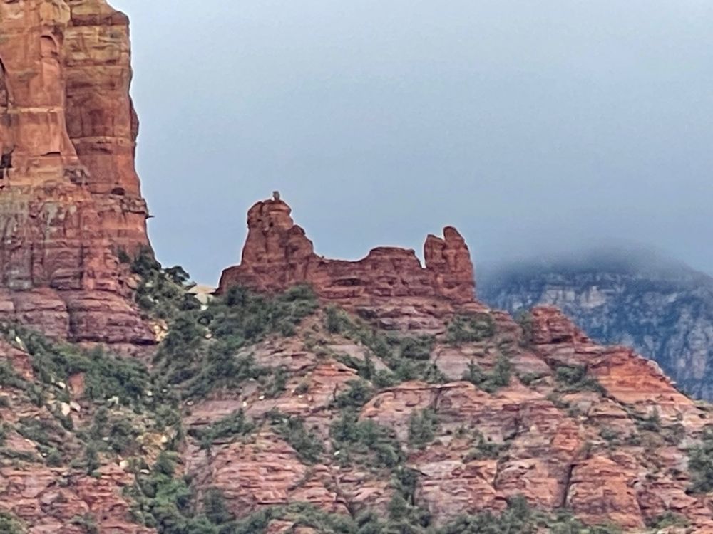 Snoopy Rock is a redrock formation that resembles Snoopy lying on top of his doghouse.  Here it’s silhouetted against low clouds.