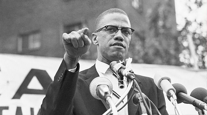 A photo of Malcolm X standing at a podium